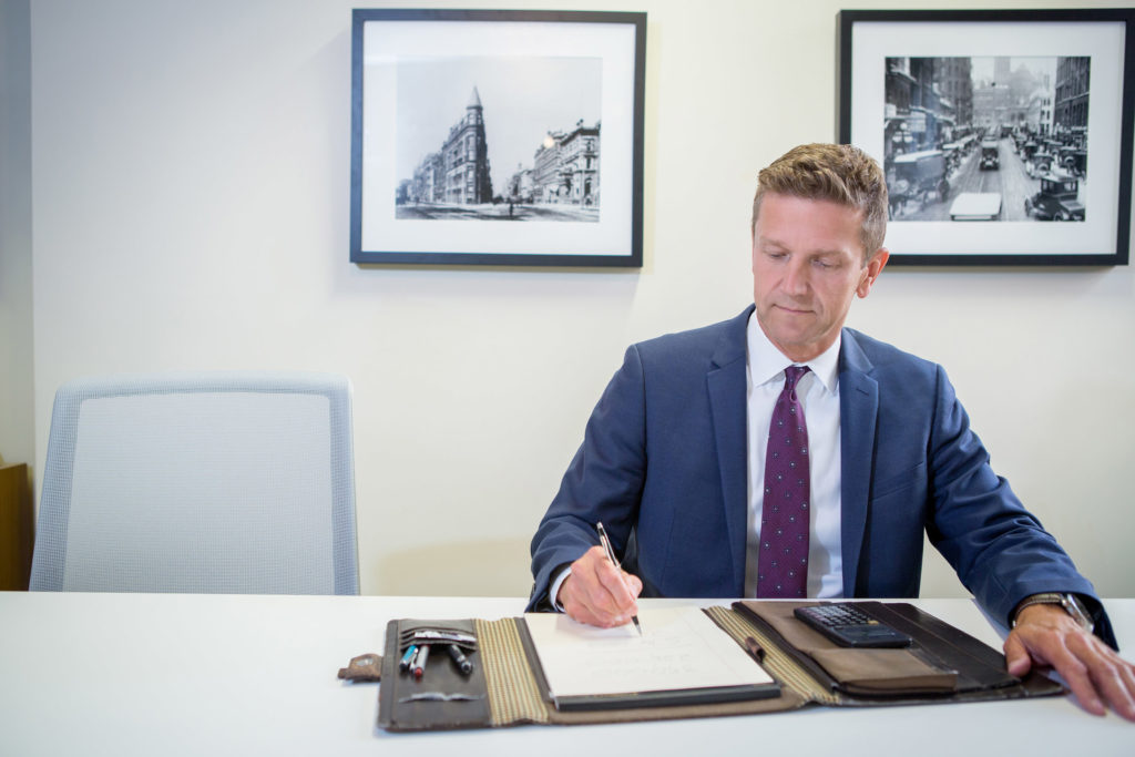 Kurt Rosentreter meeting at his Toronto office with pad and notes